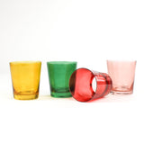 Four colored drinking glasses in pink, red, green and yellow from madcap cottage