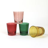 Four colored drinking glasses in pink, red, green and yellow from madcap cottage