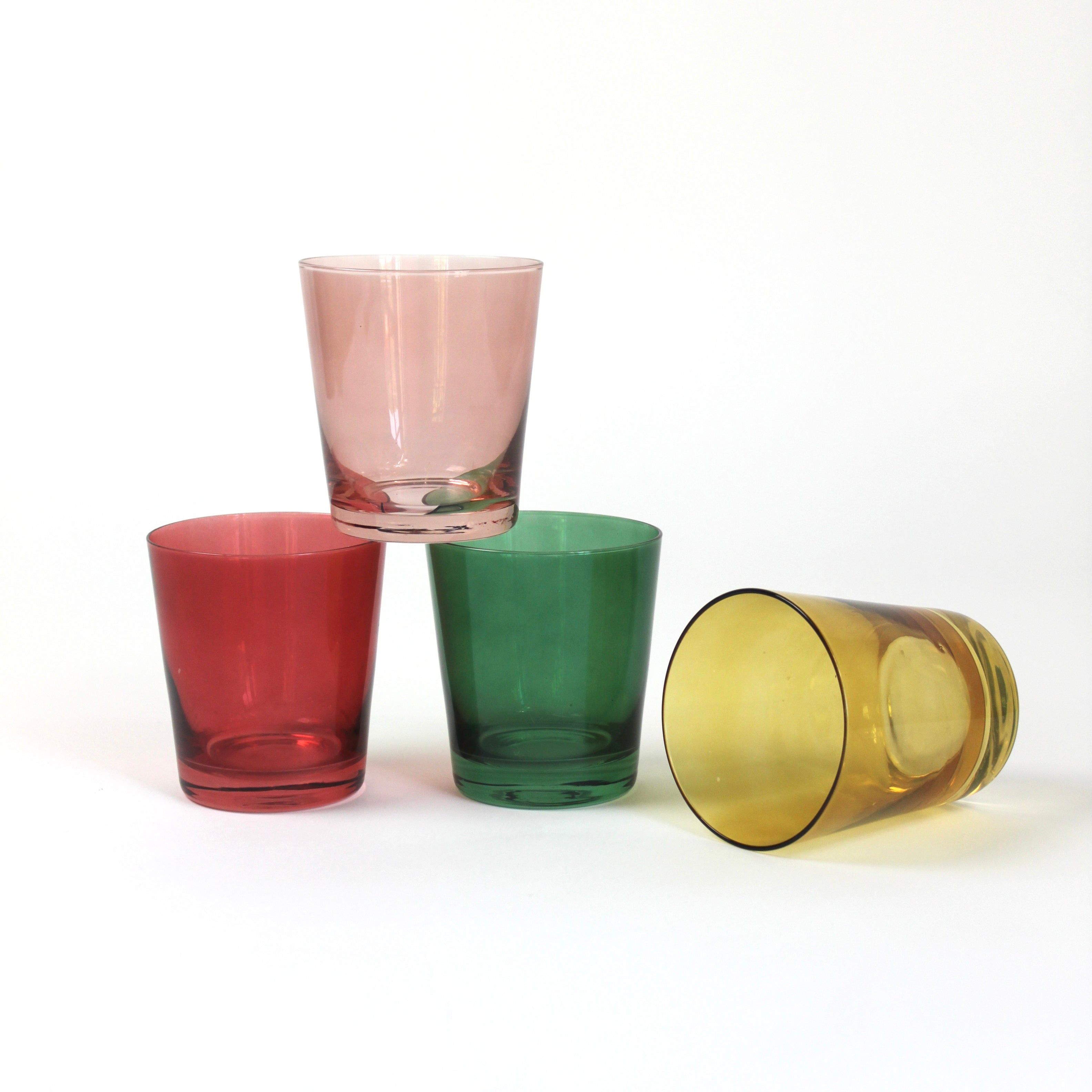 Four colored drinking glasses in pink, red, green and yellow from madcap cottage