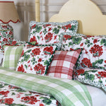 geranium print bedding featuring a reversible duvet with a green gingham reverse side on a yellow canopy bed. 