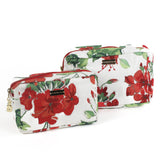 Cottage Grove Geranium is a floral toiletries bag with a red, green, and white color scheme, featuring a geranium design.