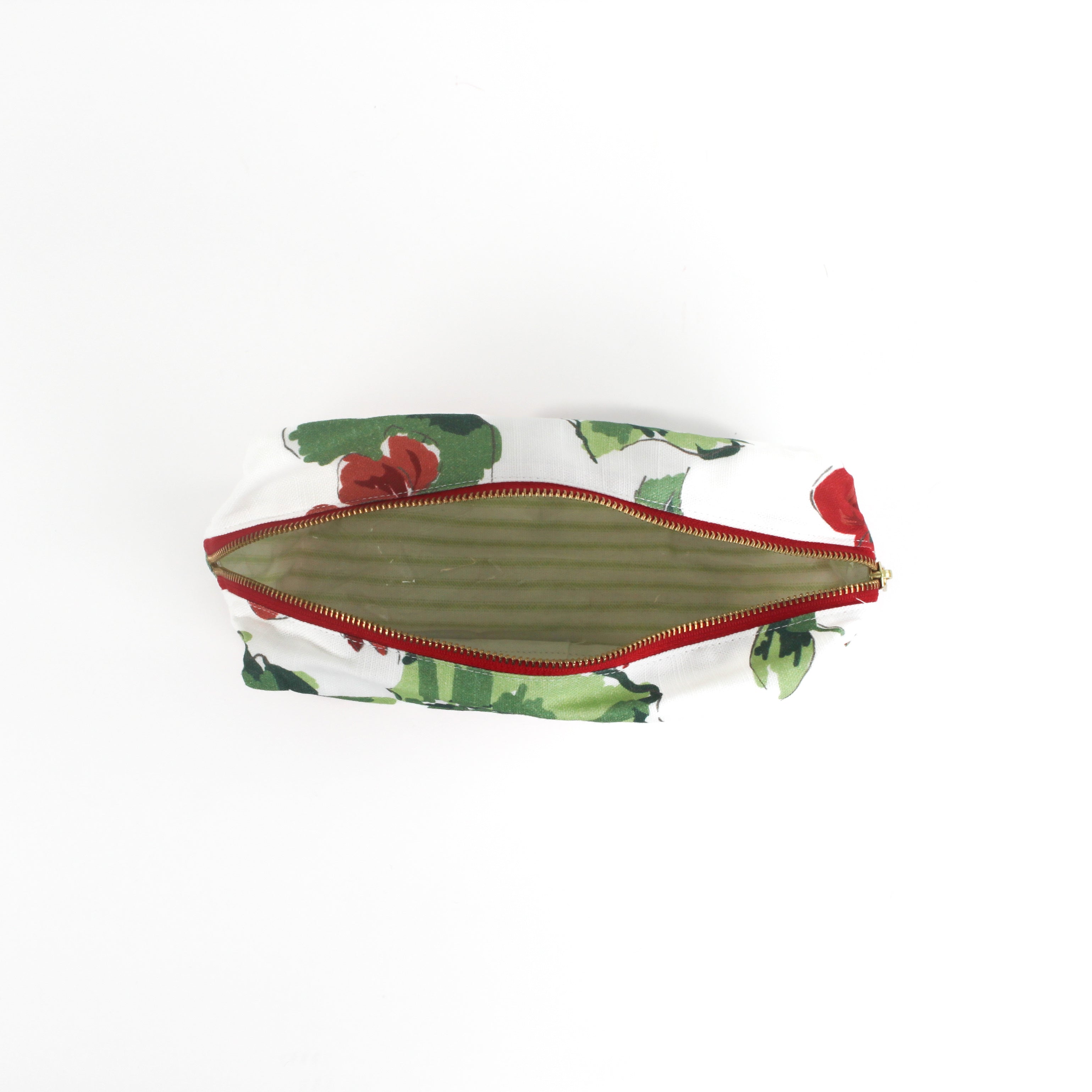 inside of large Cottage Grove Geranium, a floral toiletries bag with a red, green, and white color scheme, featuring a geranium design.