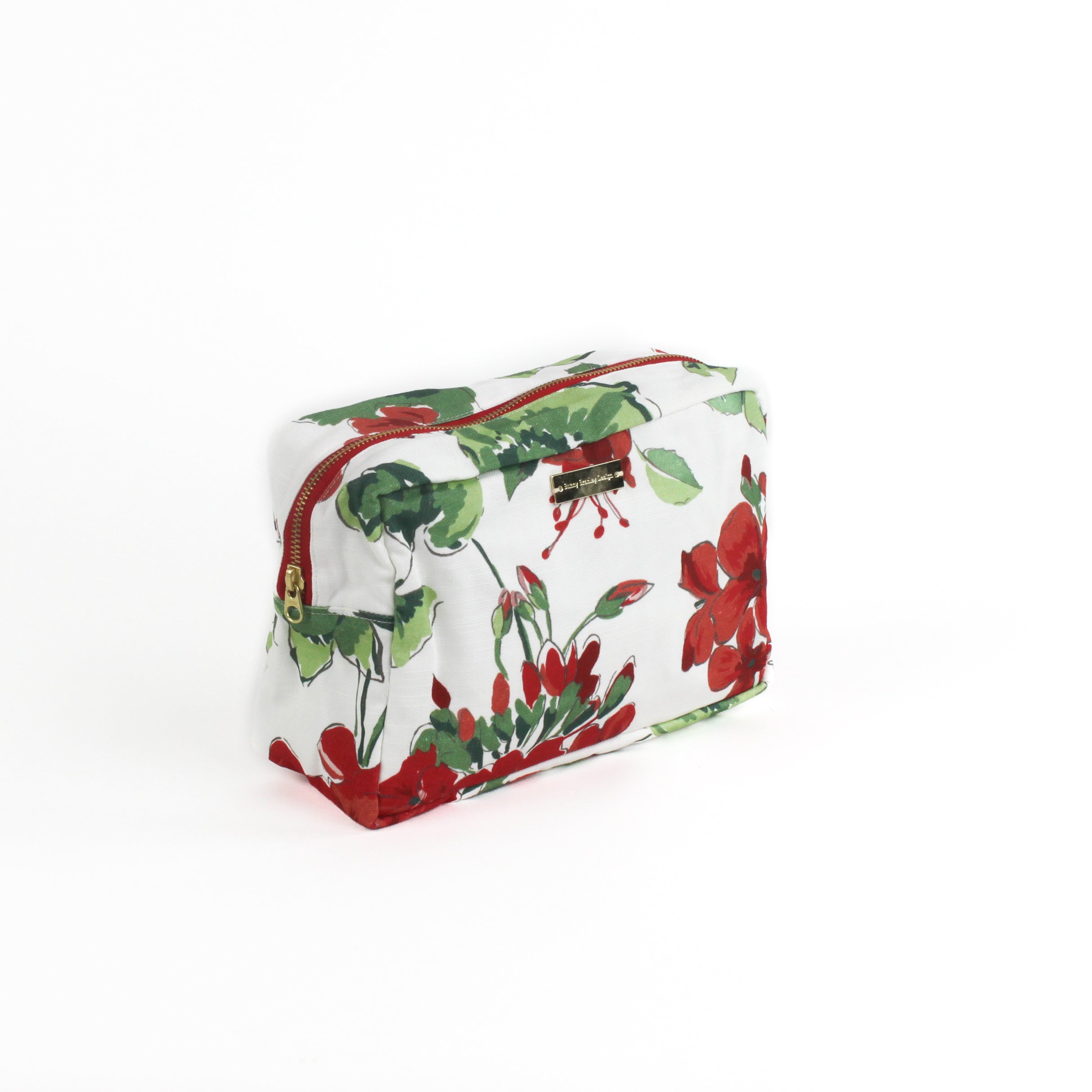 angle view of a large Cottage Grove Geranium, a floral toiletries bag with a red, green, and white color scheme, featuring a geranium design.