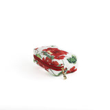 a medium Cottage Grove Geranium, a floral toiletries bag with a red, green, and white color scheme, featuring a geranium design.