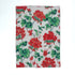 a white floral tea towel featuring a pattern of red geranium motifs against a white background. 