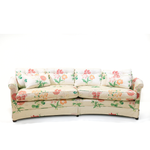 A curved pastel vintage floral sofa