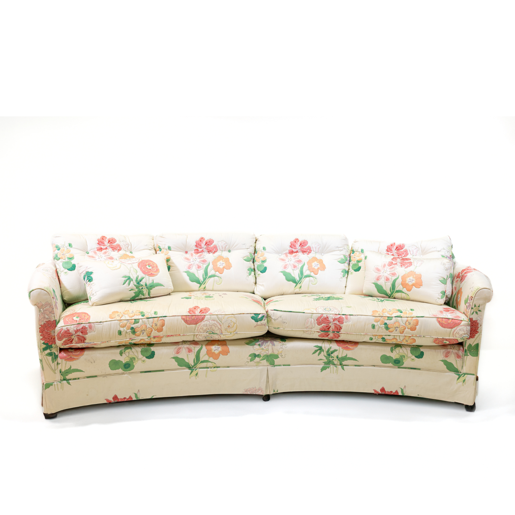 A curved pastel vintage floral sofa