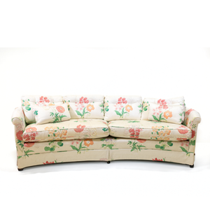 A curved pastel vintage floral sofa