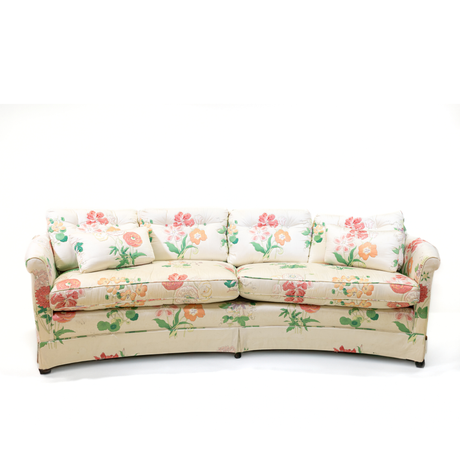 A curved pastel vintage floral sofa
