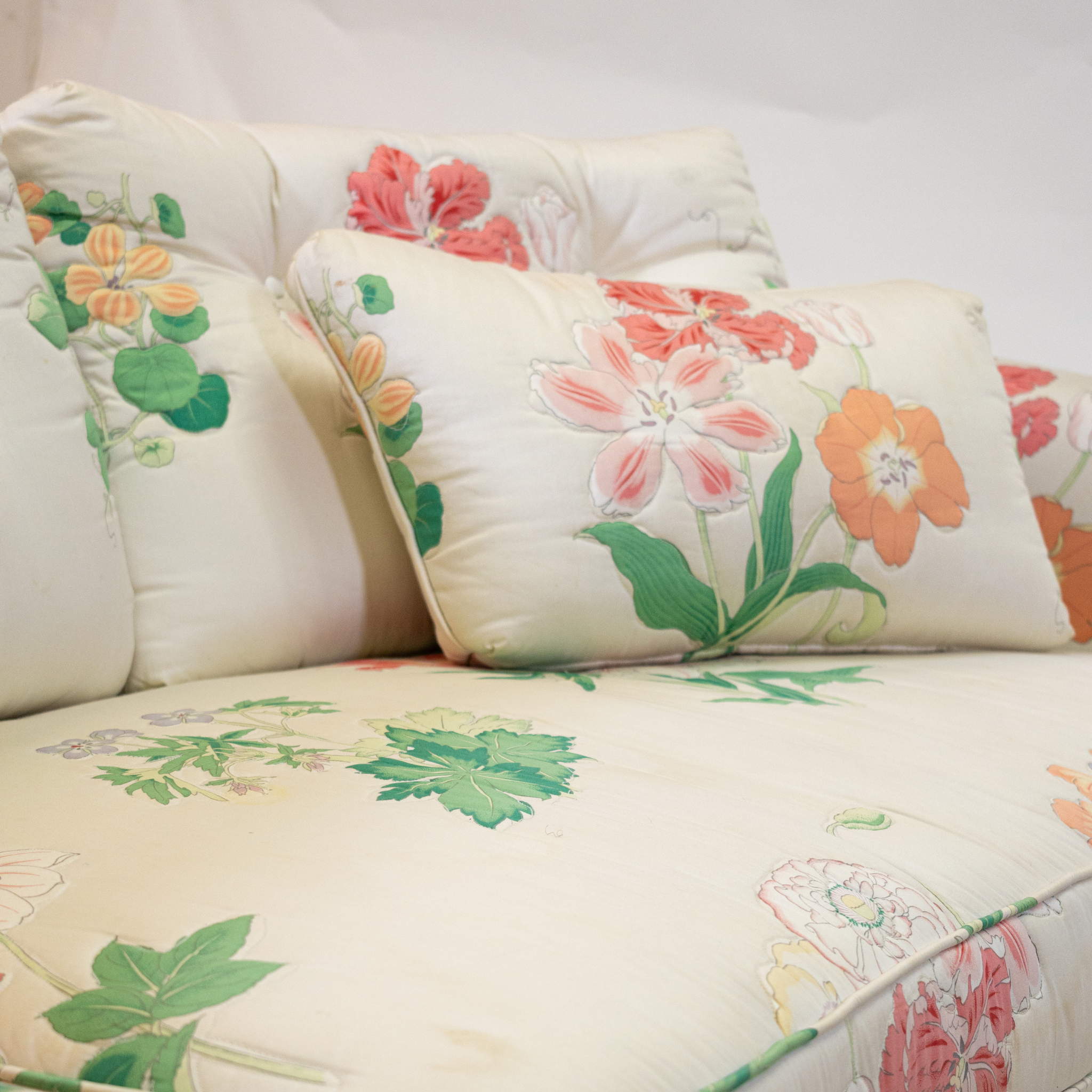 the cushion of a pastel floral sofa