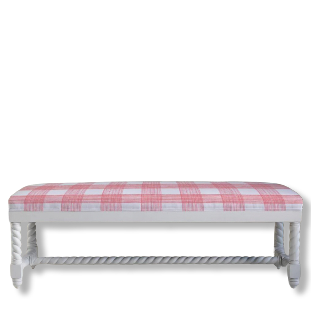 White bench with a pink and white checkered upholster on a white background