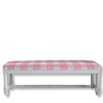 White bench with a pink and white checkered upholster on a white background