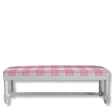 White bench with a pink and white checkered upholster on a white background