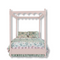 A pink canopy bed with floral bedding.