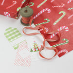 colorful cute christmas wrapping paper with colored candy cane motifs