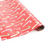 Roll of red candy cane wrapping paper on a white background.