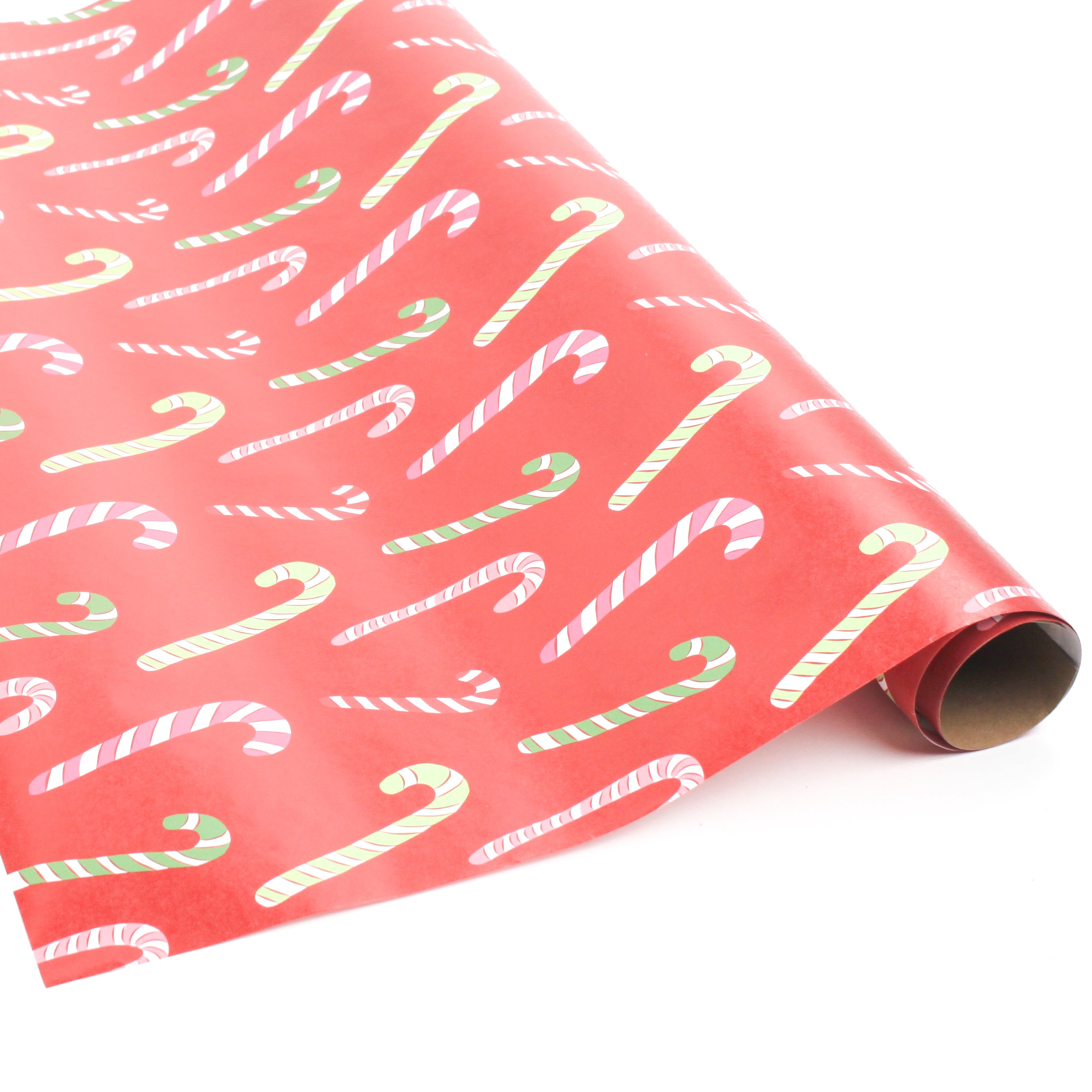 Roll of red candy cane wrapping paper on a white background.