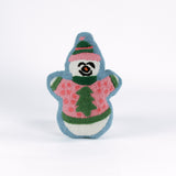 Snowman-shaped decorative pillow with a hooked texture, featuring a smiling snowman wearing a pink sweater with a green Christmas tree design and a matching blue and pink hat.