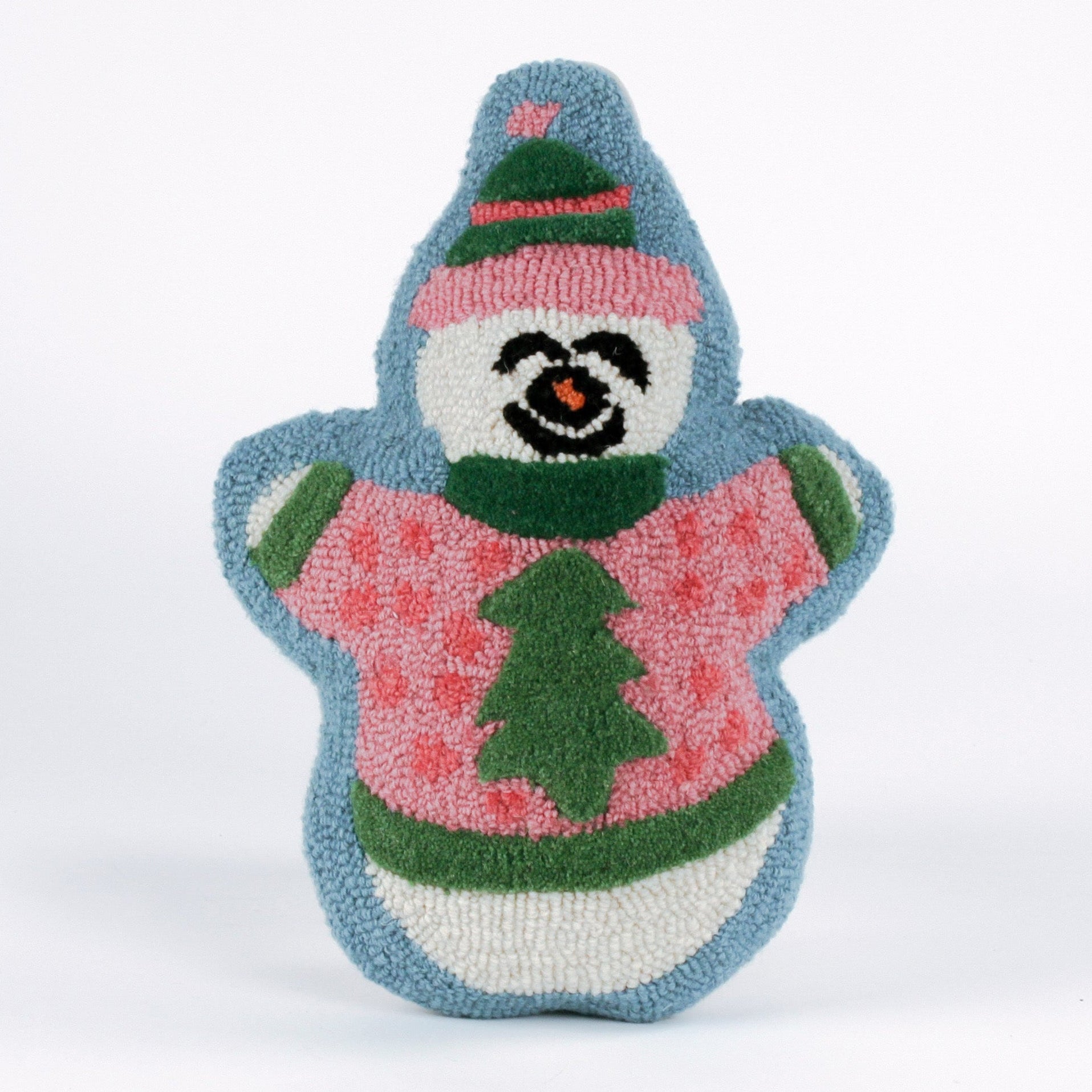Snowman-shaped decorative pillow with a hooked texture, featuring a smiling snowman wearing a pink sweater with a green Christmas tree design and a matching blue and pink hat.