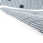 reverse of A blue accent rug with a daisies pattern on it