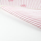 reverse of A pink accent rug with a daisies pattern on it