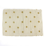 A yellow accent rug with a daisies pattern on it