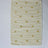 A rectangular yellow accent rug with small daisy shaped accents scattered across it. 