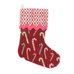 Red Christmas stocking with candy cane pattern on a white background