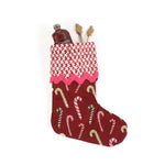 a red candy cane christmas stocking with a red and white blockprint patterned cuff. 