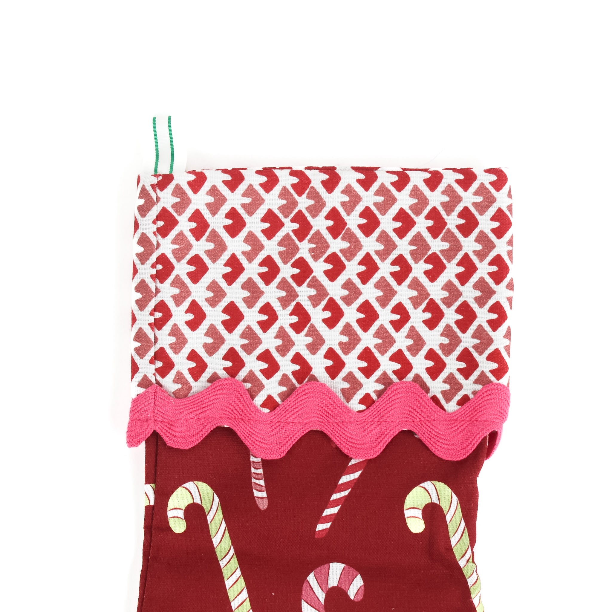 a red candy cane christmas stocking with a red and white blockprint patterned cuff. 