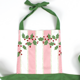 Madcap Cottage Pink and White Striped apron with Christmas designs on a white background close up