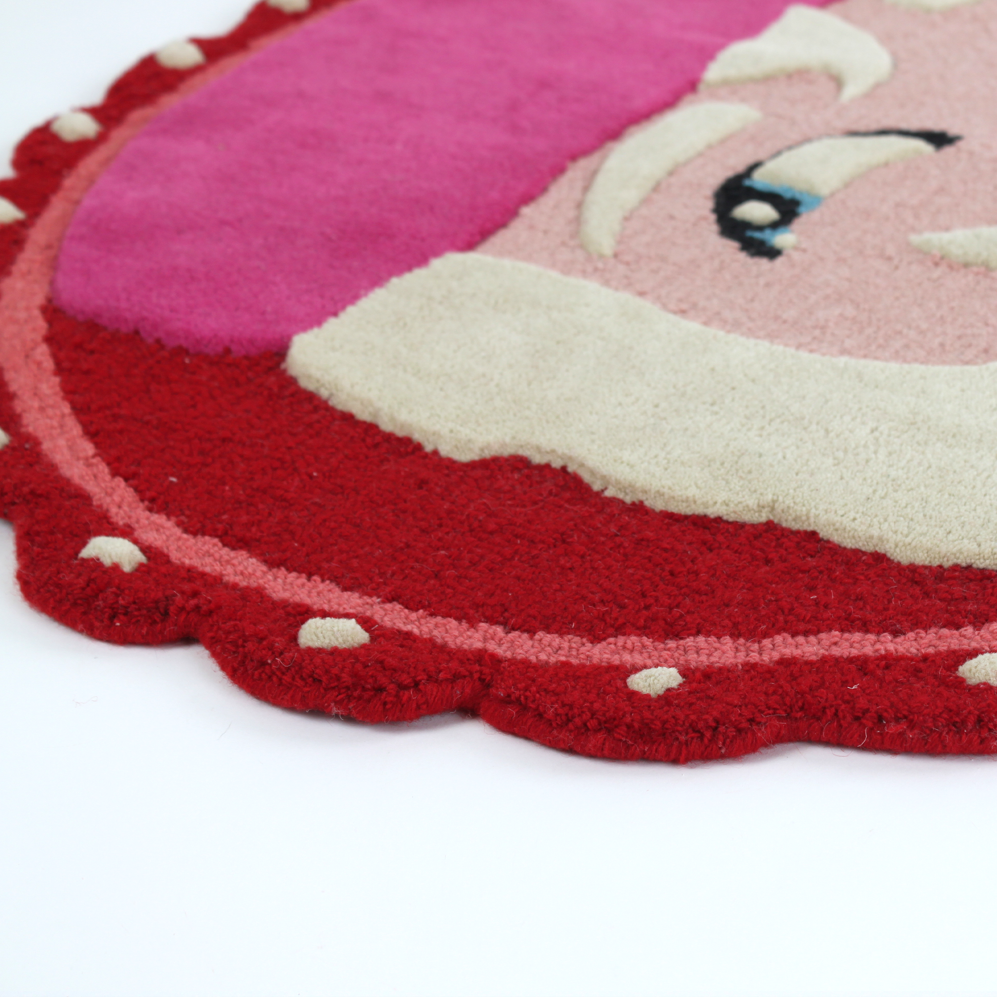 close up details of An oval Christmas rug featuring a large santa face