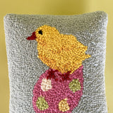 close up of A purple easter pillow with two easter eggs with a yellow chick on top