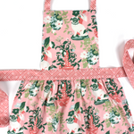 Madcap Cottage Floral apron with pink and green design on a white background