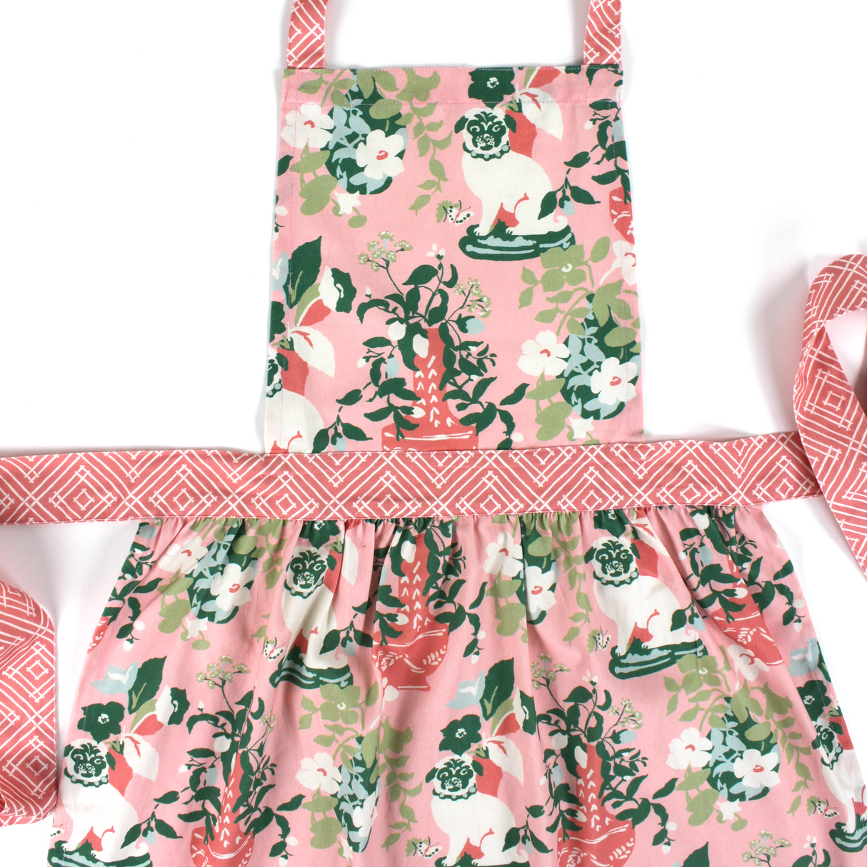 Madcap Cottage Floral apron with pink and green design on a white background