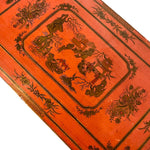 a dark wood chinoiserie side table with two tiers and on rolling casters.