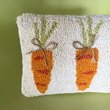 close up of A white easter pillow with three orange carrots