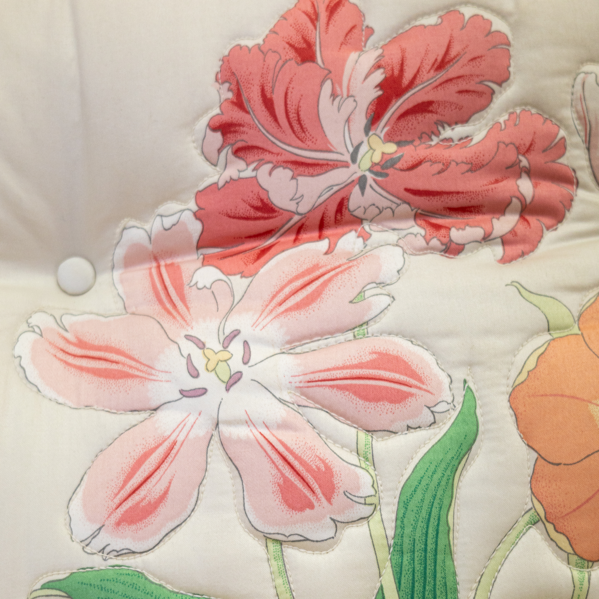 coral colored lily motifs on a vintage floral sofa