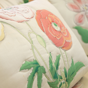 an orange poppy detail on a vintage floral sofa