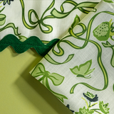 a close up of Bunnies and bow print fabric easter napkins in green. 