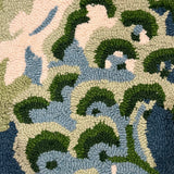 a close up of a blue and green rug with chinoiserie boatmen and pagoda motifs from madcap cottage.