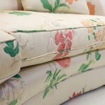 a close up of a floral vintage sofa