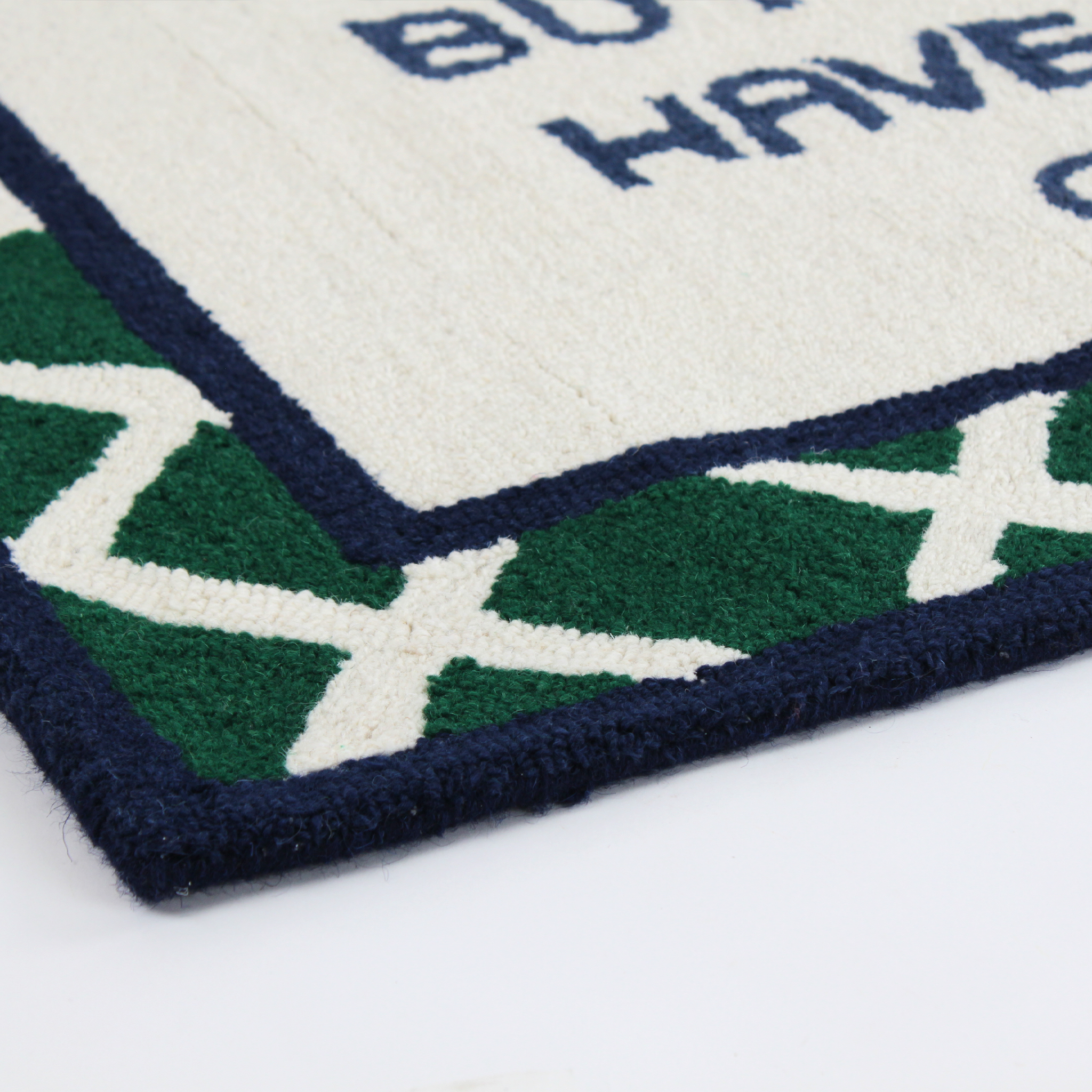 close up detail of a Dogs Don't Have to Go to College Navy/Green Hooked-Wool Rug