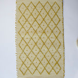 A recycled cotton yellow accent rug with a repeating diamond motif from Madcap Cottage. 