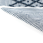 reverse of A blue accent rug with a diamond pattern on it