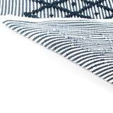 reverse of A blue accent rug with a diamond pattern on it