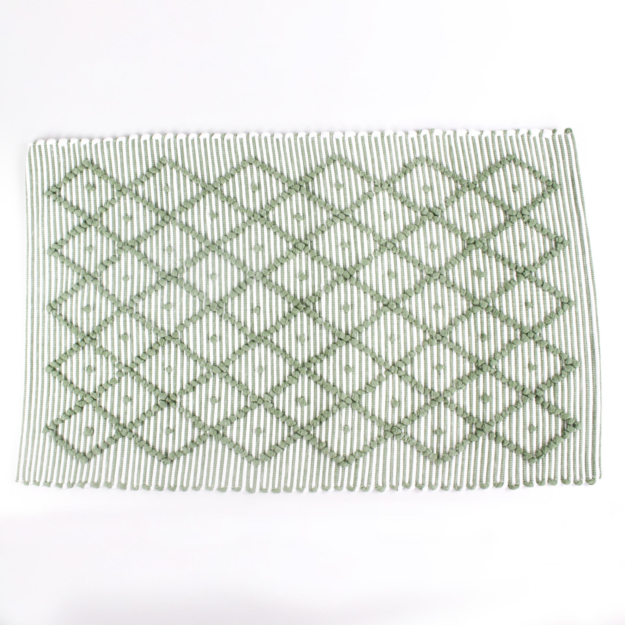 A green accent rug with a diamond pattern on it