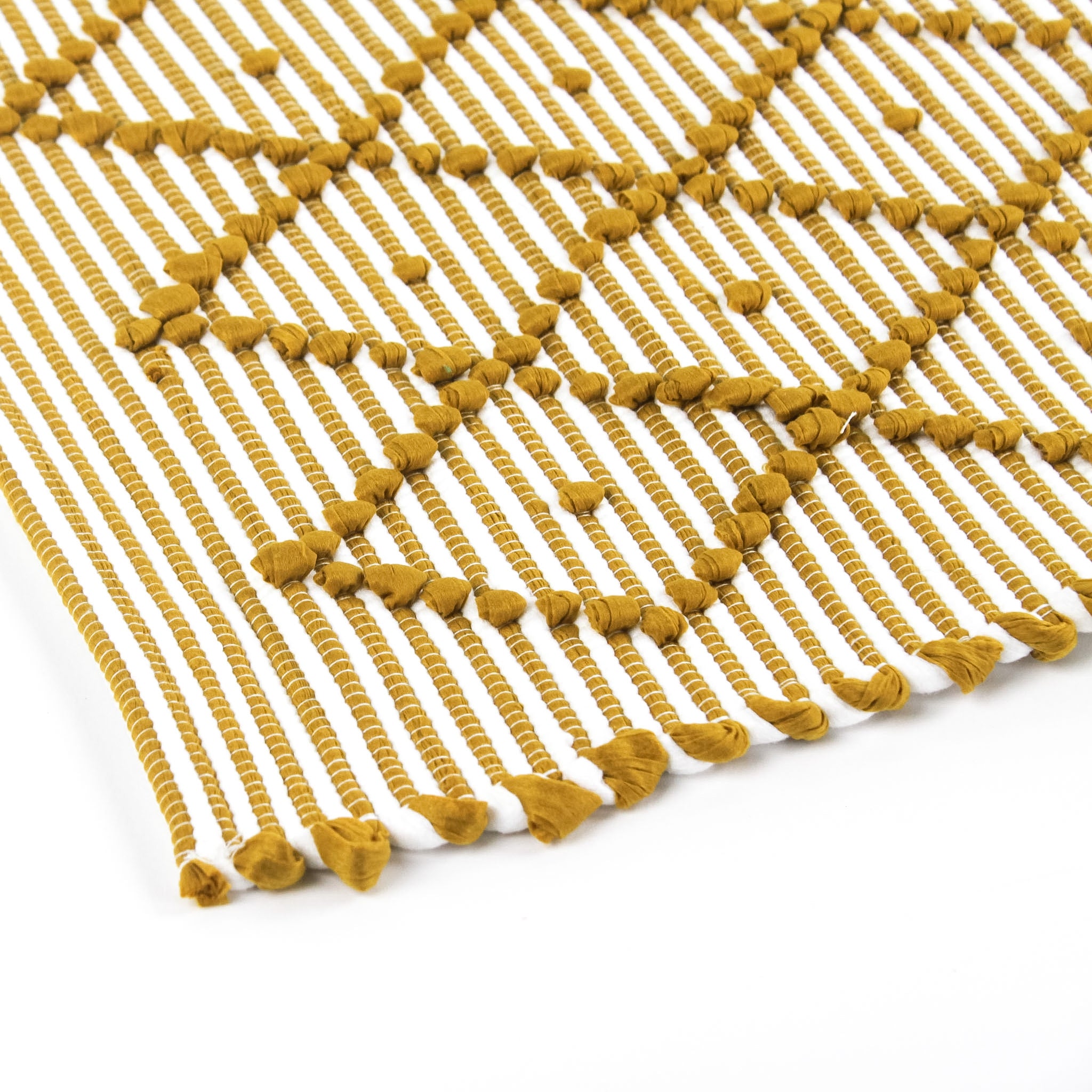 close up look of A yellow accent rug with a diamond pattern on it