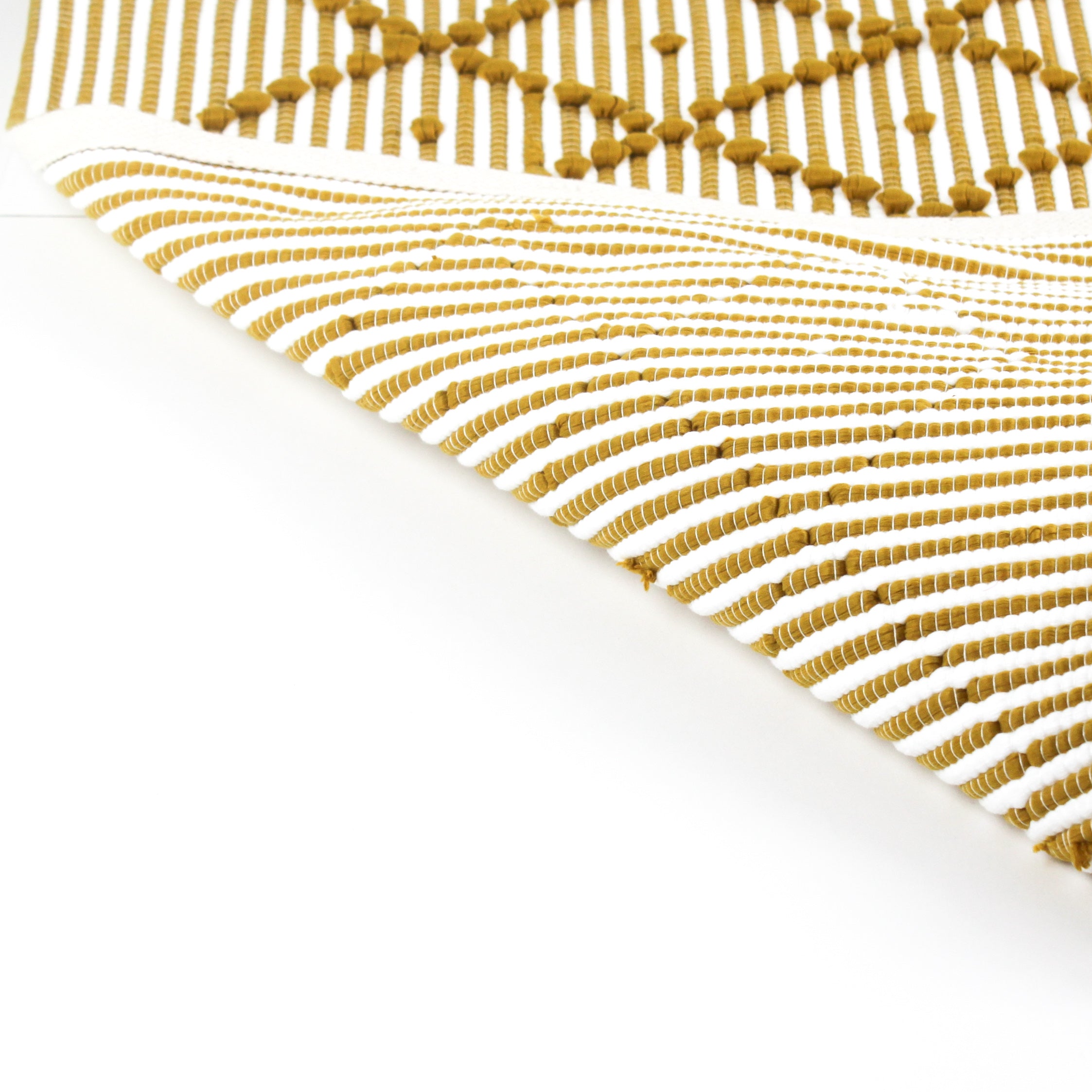 reverse side of A yellow accent rug with a diamond pattern on it
