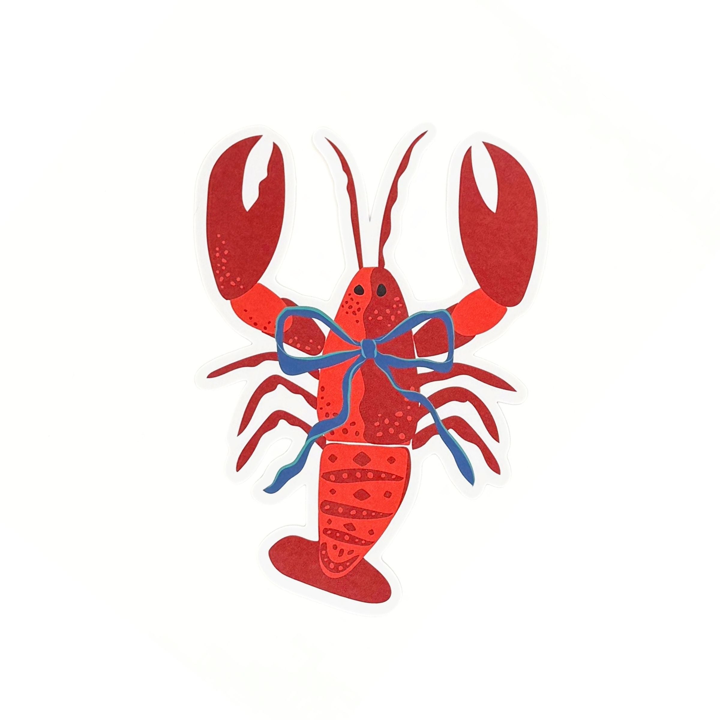 A die cut lobster shaped paper placemat featuring a red lobster design with a blue bow on a white background.